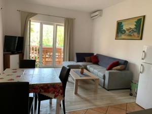 a living room with a couch and a table at Apartments Ban in Novi Vinodolski