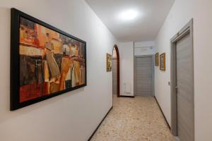 a hallway with a painting hanging on a wall at Villa Adriana in Pietra Ligure