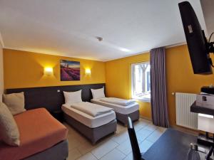 Posteľ alebo postele v izbe v ubytovaní BIVIUS Hotel Restaurant Luxembourg