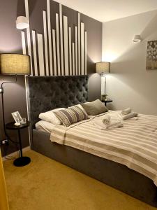 a bedroom with a large bed with a large headboard at Bed and Breakfast Veja's in Krk