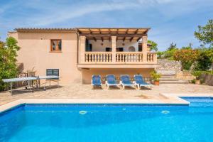 a villa with a swimming pool and a house at Ca Na Ponta in Pollença