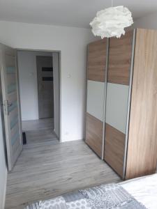 Apartament Aleksandra في كارباش: غرفة نوم بأبواب مرآة وثريا