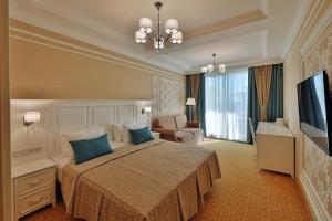 A bed or beds in a room at Dynasty Hotel