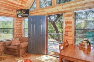 a living room with a door and a couch and a table at Arbor House of Dripping Springs - Finch House in Dripping Springs