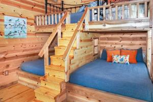 a bedroom in a log cabin with stairs at Arbor House of Dripping Springs - Finch House in Dripping Springs