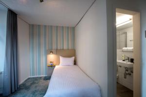 Hotel Krone by b-smart客房内的一张或多张床位