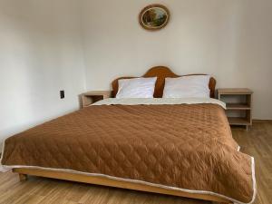 a bedroom with a large bed with two night stands at Lovin's Rooms in Tuzla