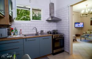 a kitchen with a sink and a stove at Mary's Dreamy Maisonette-Volos, Peaceful Area in Volos
