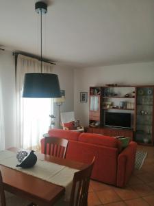 a living room with a red couch and a table at Umbriahouse in Terni