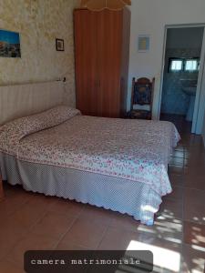 a bedroom with a bed and a chair at Il Canneto in Sassari