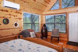 a bedroom with a bed and windows in a cabin at Arbor House of Dripping Springs - Nautical House in Dripping Springs
