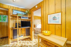 a living room with wood paneled walls and a television at Grandma's Sandbox in Beulah