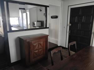 a kitchen with a counter and a table and a microwave at Ugarte in Urrugne