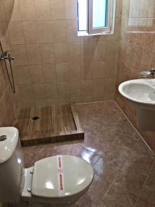 a bathroom with a toilet and a sink at Santa Maria in Burgas City +48 photos