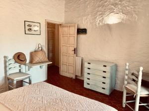a bedroom with a bed and a table and chairs at Eleni Room in Costa Dorata