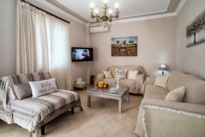 a living room with a couch and a table at Mary's Dreamy Maisonette in Volos