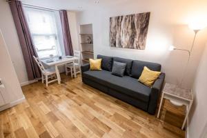 a living room with a couch and a table at ☆ New Superhost Listing- Broughty Ferry Studio ☆ in Broughty Ferry