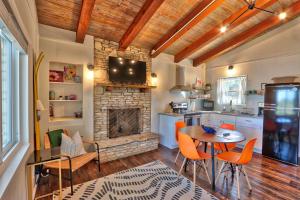 cocina con mesa, sillas y chimenea en Millie's Waterfront Cottages Unit 4 - Clara, en Canyon Lake