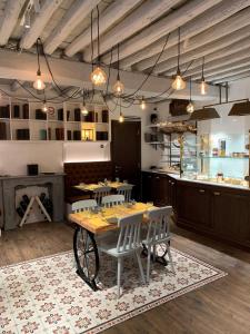 a restaurant with a table and chairs and a counter at Les Fleurs Luxury House in Rome
