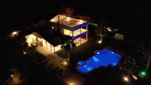 an aerial view of a house at night with a swimming pool at ALASHATO Alacati in Alaçatı