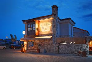 a building with a sign on the side of it at Rijeka Alaçatı in Çeşme