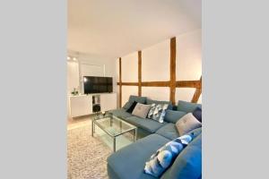 ein Wohnzimmer mit einem blauen Sofa und einem Glastisch in der Unterkunft Luxury 'Kings Garden' City-Flat In Center Of Town in Kopenhagen