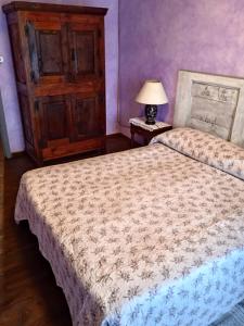 a bedroom with two beds and a table with a lamp at A REALDO - Casa Il Nido Delle Aquile in Triora