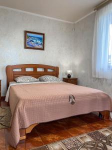 a bedroom with a large bed with a pink blanket at Morskyi 487 in Zatoka