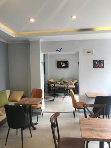 a dining room with tables and chairs in a room at My Way Cadde Butik Otel in Adalar