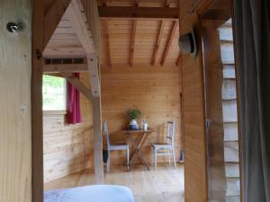 a room with a table and chairs in a cabin at Ô Bois Dormant in Lempzours +96 photos