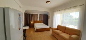 una camera d'albergo con un letto e un divano di Vivenda Maresol a Sagres