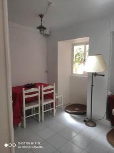 a room with a table and a lamp and a window at Casas do Patio sem Cantigas 1 in Sintra +29 photos
