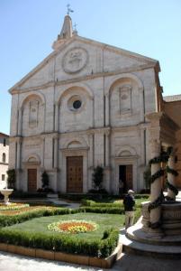 a man standing in front of a church at Camere Gozzante in Pienza