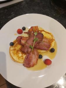 a plate of food with bacon and blueberries on it at B&Bat no3 in Market Bosworth +76 photos