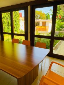 a conference room with a table and chairs and windows at Hotel Casa San Juan in Managua