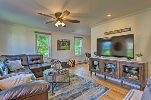 a living room with a large flat screen tv at Updated Home with Patio Half Mile to West Point in Highland Falls