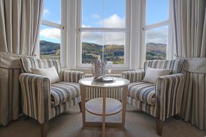 a living room filled with furniture and a window at Tigh Na Cloich Hotel in Pitlochry