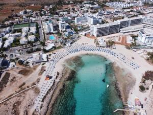 an aerial view of a beach with a swimming pool at Anonymous Beach Hotel (Adults 16+) in Ayia Napa