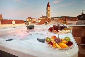 
a glass bowl filled with fruit on top of a boat at Palace Derossi in Trogir
