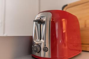 a red toaster sitting on top of a kitchen counter at Driftwood Haus in Southampton