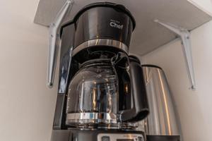 a coffee pot sitting on top of a blender at Driftwood Haus in Southampton