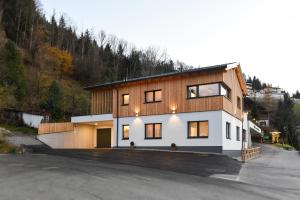 a house on a hill with a lot of windows at Ferienhaus Kraiter in Schladming