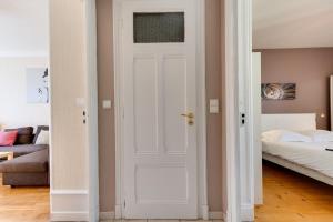 a white door in a room with a bed at Annecy Triangle d'Or - 3 bedroom apartment in Annecy +13 photos