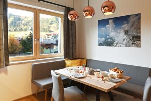 a dining room with a table and a window at Ferienhaus Kraiter in Schladming