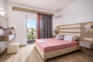 a bedroom with a bed and a balcony at Dimitra Faliraki Center Apartments in Faliraki