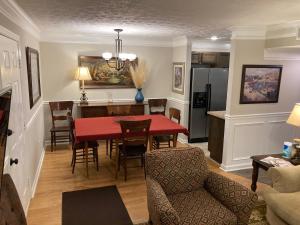a kitchen and dining room with a red table and chairs at Spacious 3 Bedroom 2 bath Condo close to Five-points in Athens in Athens