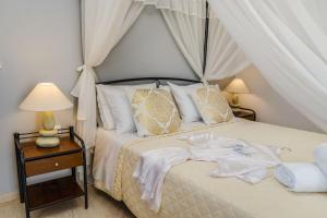 a bedroom with a bed with a canopy at Stavros Villas in Karterados
