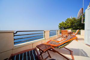 two chairs sitting on a balcony overlooking the ocean at Big Blue Apartments in Dubrovnik