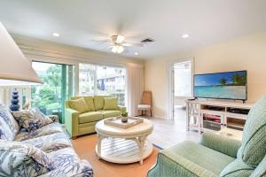 a living room with a couch and a tv at Kingston Arms 1st Floor in Sarasota