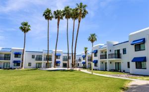 a row of palm trees in front of a building at Serene Vegas Boutique Hotel Las Vegas in Las Vegas